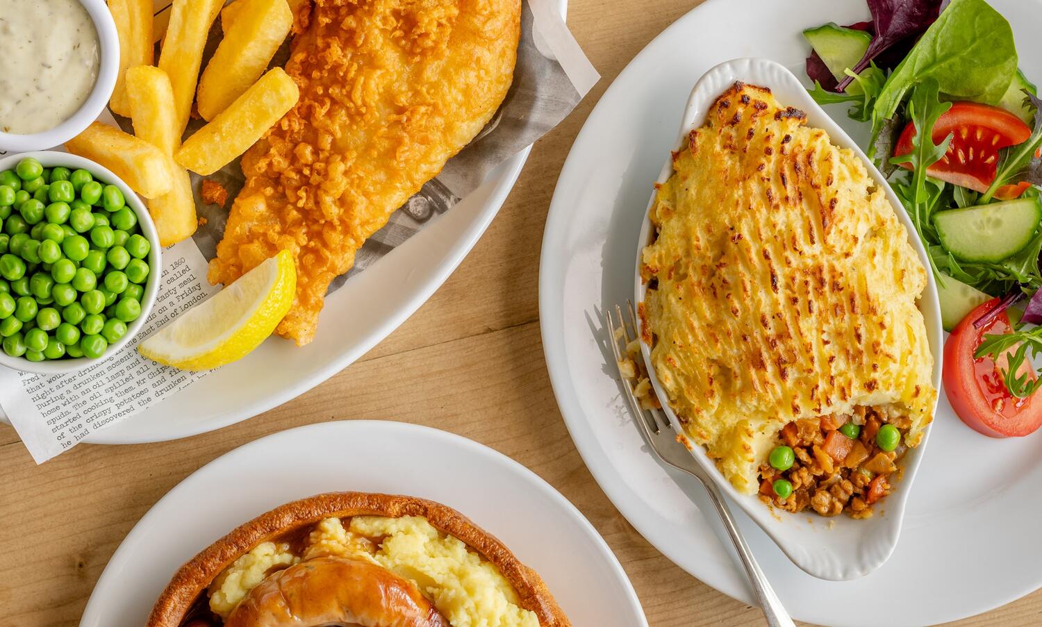 A mixture of meals, fish and chips, cottage pie and sausages and mash