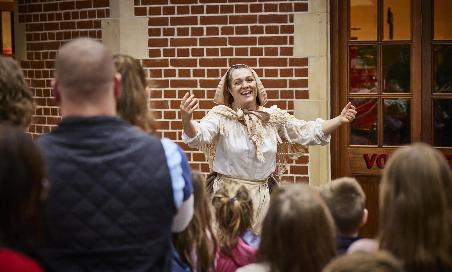 Costumed Actor entertaining a crowd