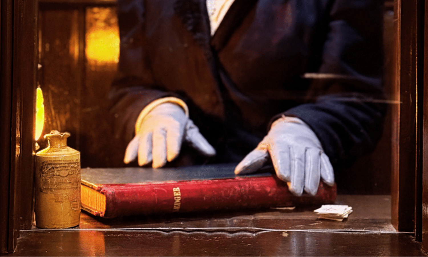 Gloved hands over book
