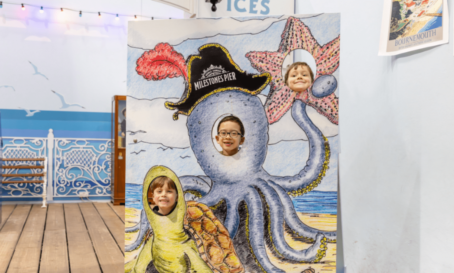 Boys posing in seaside themed cutout