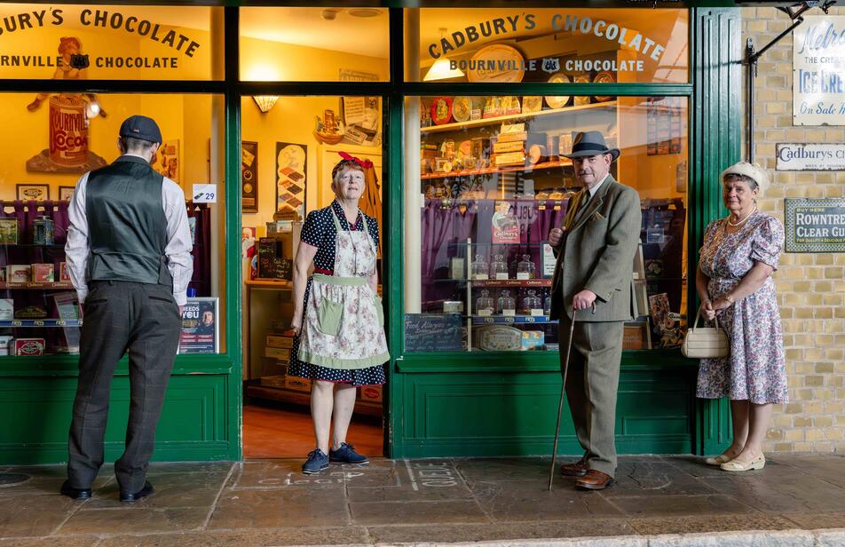Selection of costumed volunteers outside the sweetshop