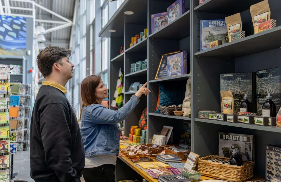 People looking at items on gift shop shelves