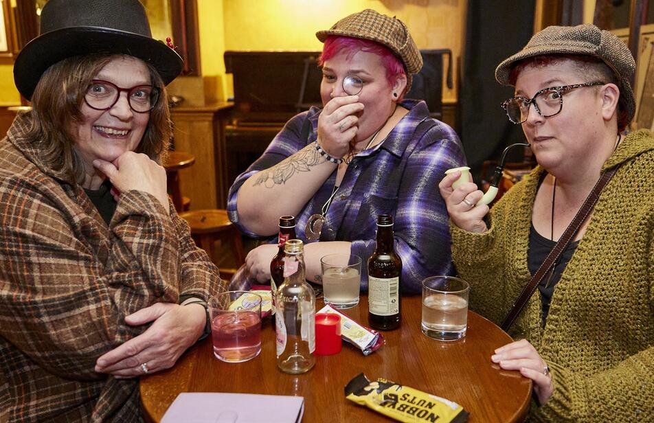 Group of friends having a day out as Sherlock Holmes enthusiasts