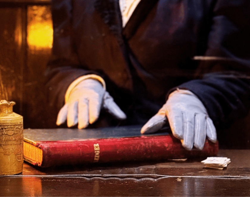 Gloved hands over book