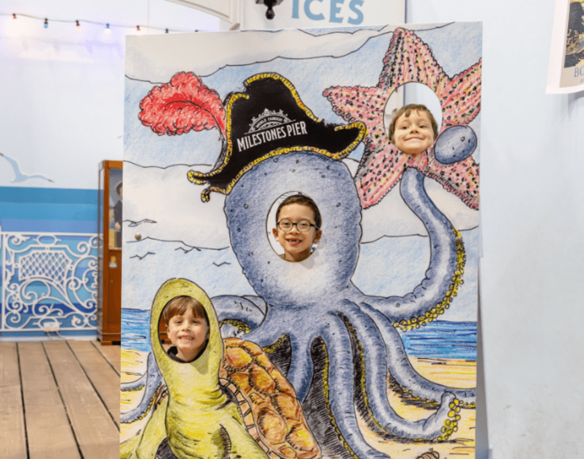 Boys posing in seaside themed cutout