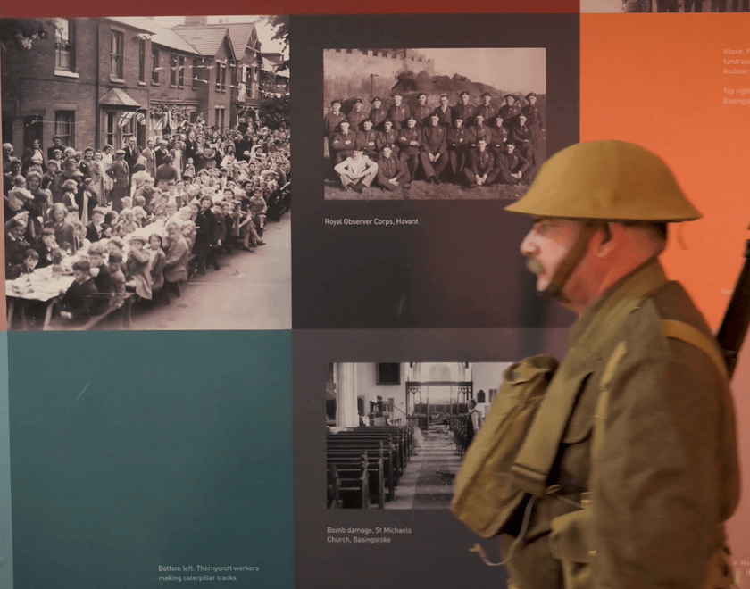 Soldier walking in front of memorial wall