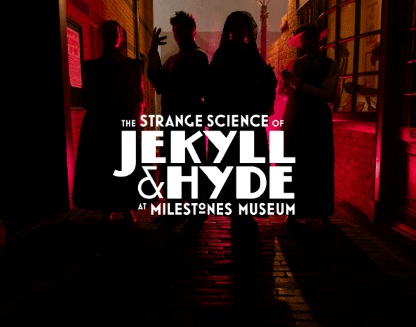 four silhouetted characters on dark street in red light with event logo