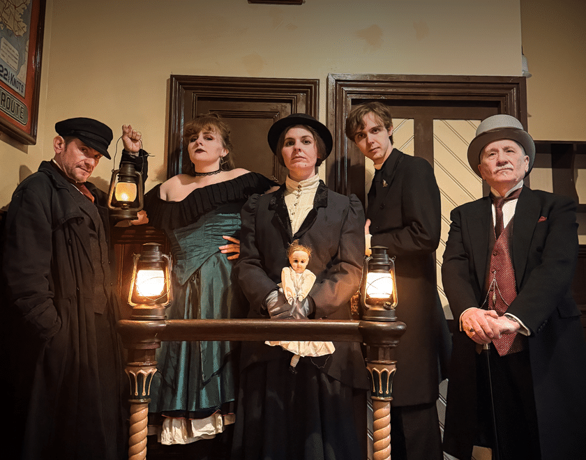 five victorian characters looking sinister in an office