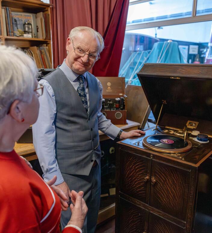 Costumed volunteer greeting a visitor in the record shop